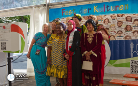 Eine Gruppe Frauen verschiedener kultureller Herkunft macht gemeinsam ein Foto.